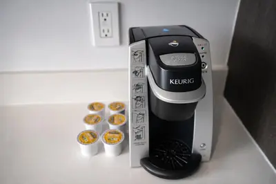 a coffee maker in a box on a counter with donuts at Downtown Skyline Heights with Stunning Ocean View in Miami
