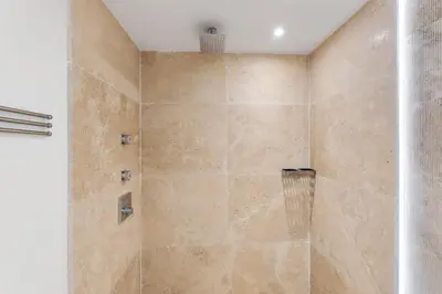 a bathroom with a shower with a glass door at Amazing Ocean and 1 Hotel pool Views 2BR 3BA w Balcony in Miami Beach