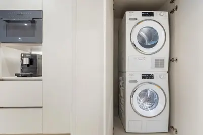 a laundry room with two washer and dryer at Amazing Ocean and 1 Hotel pool Views 2BR 3BA w Balcony in Miami Beach