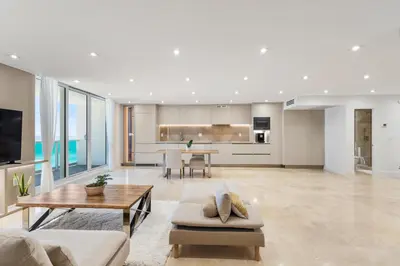 a living room with a couch and a table at Amazing Ocean and 1 Hotel pool Views 2BR 3BA w Balcony in Miami Beach