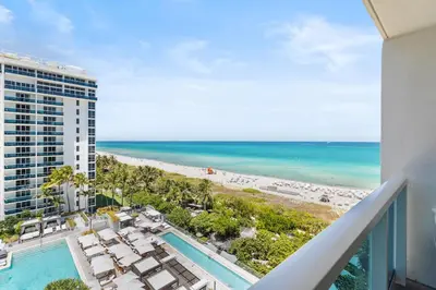 a view of the beach from the balcony of a building at Amazing Ocean and 1 Hotel pool Views 2BR 3BA w Balcony in Miami Beach