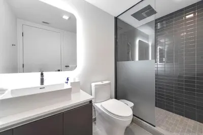 a bathroom with a toilet and a sink and a shower at Stylish Studio in Brickell Core in Miami