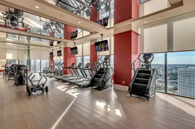 a gym with treadmills and ellipticals in a building at Luxury 2 Bedroom Corner Unit Crosby Rooftop Pool in Miami