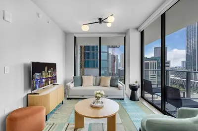a living room with a couch and a table at Luxury 2 Bedroom Corner Unit Crosby Rooftop Pool in Miami