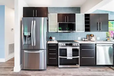 a kitchen with a stainless steel refrigerator at Stylish 2BR Oasis with Pool Mini Golf & BBQ in Fort Lauderdale
