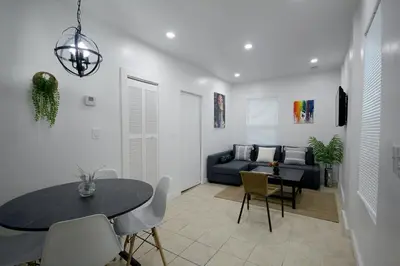 a living room with a table and a couch at Historical Little Havana 2 Bed with Parking in Miami