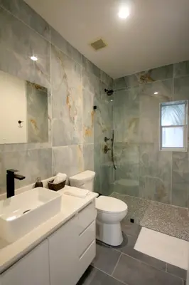a bathroom with a white sink and a toilet at Historical Little Havana 2 Bed with Parking in Miami