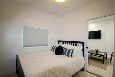a bedroom with a bed with pillows and a window at Historical Little Havana 2 Bed with Parking in Miami