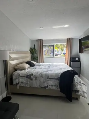 a bedroom with a large bed and a window at Private Studio with Patio-King Bed, Near Beach & Casinos in Hollywood