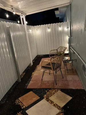 two chairs and a table on a patio at night at Private Studio with Patio-King Bed, Near Beach & Casinos in Hollywood