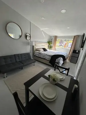 a bedroom with a bed and a table with plates on it at Private Studio with Patio-King Bed, Near Beach & Casinos in Hollywood