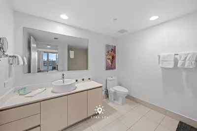 a white bathroom with a sink and a toilet at Peaceful Bay View Apartment Near Beach in Hallandale Beach
