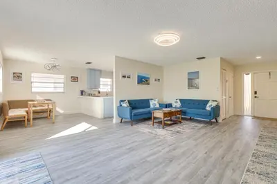 a living room with blue couches and a table at Walk to Shops and Eats, 3 Mi to Beach! Hollywood Gem in Hollywood