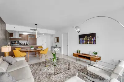 a living room with a white couch and a table at Amazing 1bed at The W icon brickell in Miami