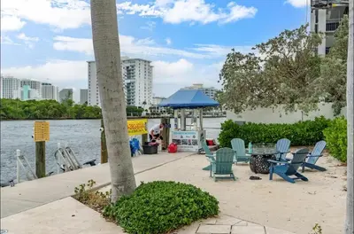 a group of chairs and a table next to the water at Family Tides At GalleryOne in Fort Lauderdale