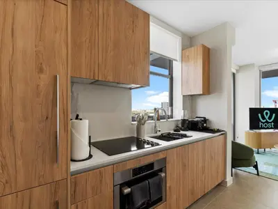 a kitchen with wooden cabinets and a counter top at Central Downtown Condo - Rooftop Pool Access in Miami