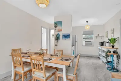 a kitchen and dining room with a table and chairs at Santorini Blu Elegant 1BR Beach Retreat On the Beach in Hollywood
