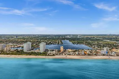 an aerial view of a beach with buildings and the ocean at Santorini Blu Stylish Coastal Studio on the Beach in Hollywood