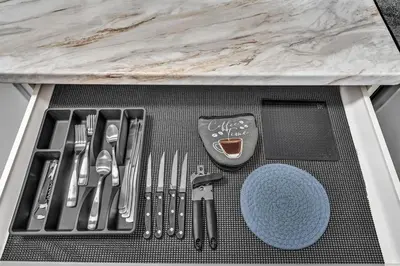 a table with utensils on a tray under a counter at Santorini Blu Stylish Coastal Studio on the Beach in Hollywood