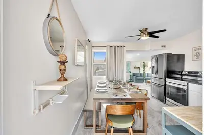 a kitchen with a table and a mirror at Santorini Blu Spacious 2BR Beachfront Suite in Hollywood