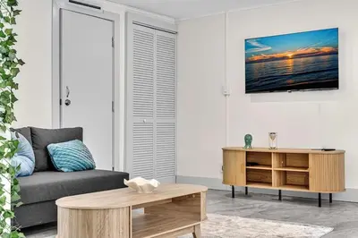a living room with a couch and a table at Santorini Blu Spacious 2BR Beachfront Suite in Hollywood