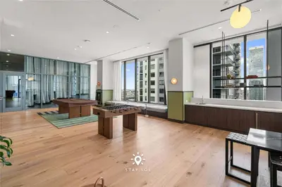 a large room with a table and some windows at 1BR Apartment New Luxury in Miami