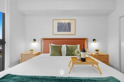 a bedroom with a bed and a table with a bottle of wine at 1BR Apartment New Luxury in Miami