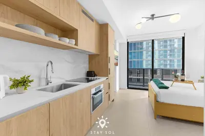a kitchen with a sink and a large window at Stylish Miami Studio Perfect for City Living in Miami
