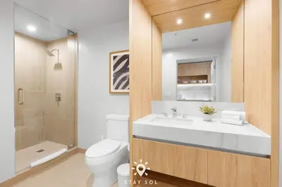 a bathroom with a toilet and a sink and a shower at Downtown Retreat Pools Spa & Lounges Miami in Miami