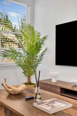 a living room with a table with a tv at Victoria Park Oasis Walk to las Olas Beach in Fort Lauderdale