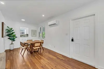 a dining room with a table and a white door at Victoria Park Oasis Walk to las Olas Beach in Fort Lauderdale