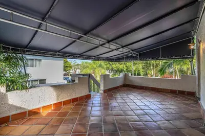 an outdoor patio with a black ceiling at Victoria Park Oasis Walk to las Olas Beach in Fort Lauderdale