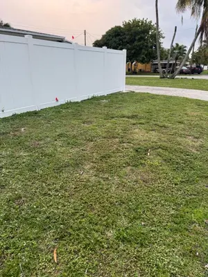a white fence in a yard with grass at Beautiful 1 bedroom Studio located in Miramar in Miramar