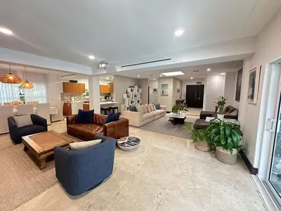a large living room with couches and a kitchen at Luxury 4BR Coconut Grove Home wIith Pool and BBQ in Miami