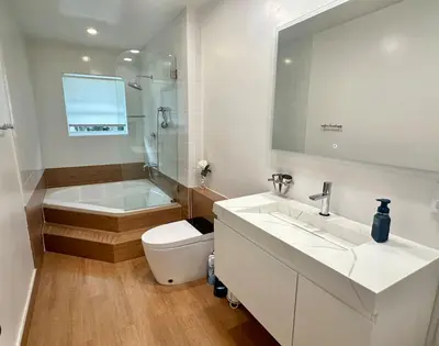 a bathroom with a sink and a tub and a toilet at Luxury 4BR Coconut Grove Home wIith Pool and BBQ in Miami