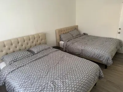 two beds sitting next to each other in a bedroom at 9064 Collins Ave 2 in Miami Beach