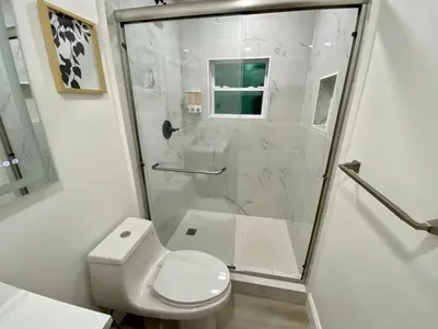 a white bathroom with a shower and a toilet at Hollywood Escape in Hollywood