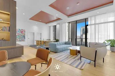 a living room with a couch and chairs at Sophisticated Studio with Pools in Miami