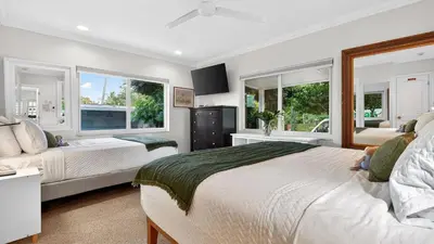 a bedroom with two beds and two windows at Casa Pineapple Social by AvantStay Spa Game Room EV Charger Near Las Olas Fort Lauderdale Beaches Sleeps 16 in Fort Lauderdale
