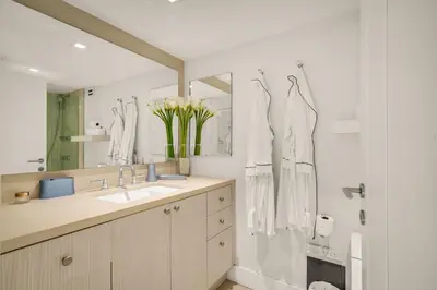 a bathroom with a sink and a mirror at Seaside Condo - Studio for 4 in Miami Beach
