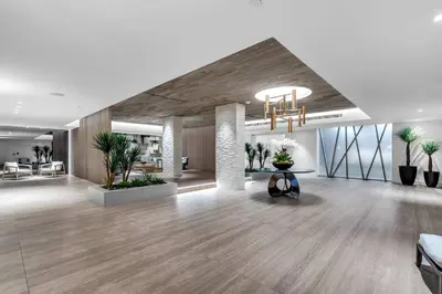 an office lobby with a chandelier and wooden floors at Seaside Condo - Studio for 4 in Miami Beach