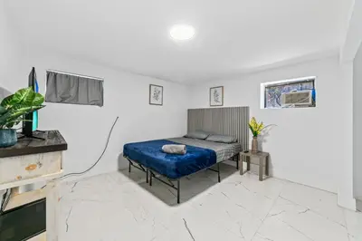 a bedroom with a bed in a white room at Casa Sol - 4 Bedroom 2 Bath - 7 beds - Affordable Stays For Large Groups in Ives Estates