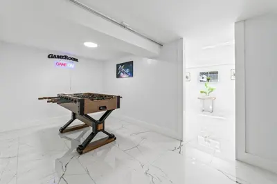 a white room with a table on a white tile floor at Casa Sol - 4 Bedroom 2 Bath - 7 beds - Affordable Stays For Large Groups in Ives Estates