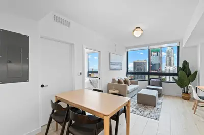 a living room with a table and chairs and a couch at Central Downtown Miami at District 225 Luxury Residence in Miami