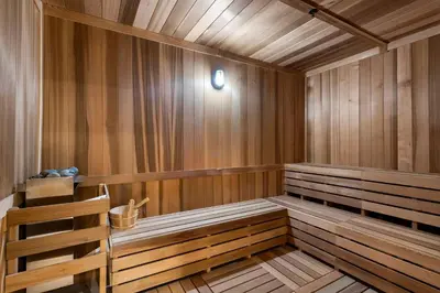 a sauna with wooden paneling and a wooden bench at Central Downtown Miami at District 225 Luxury Residence in Miami
