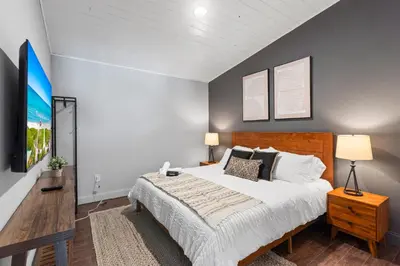 a bedroom with a large bed and a tv at Heated Pool Games Family Haven Near FIU