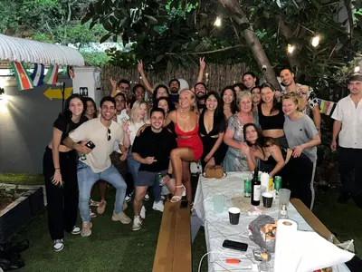 a group of people posing for a picture at a party at Kayoma Hostel in Miami