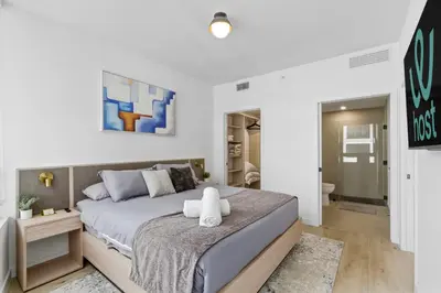 a bedroom with a large bed and a bathroom at Hotel-Style Condo at District 225 in Downtown Miami in Miami