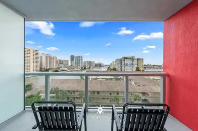 two chairs on a balcony with a view of the city at Cozy studio near beach Nice views in Hallandale Beach