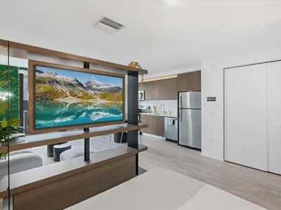 a kitchen with a large screen tv in a room at Modern Studio by Bayside & Cruise Port in Miami